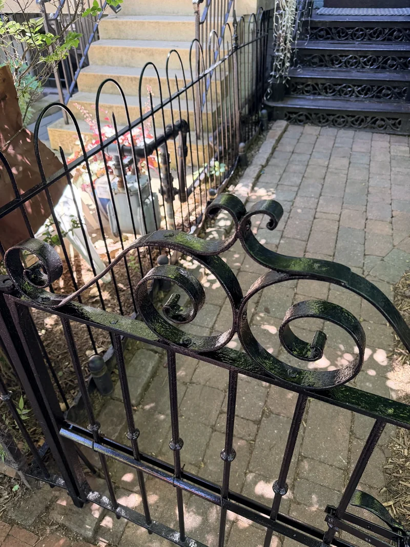Restored ornamental iron gate in front of a Capitol Hill home
